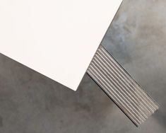 an overhead view of a white table with metal slats on the top and bottom