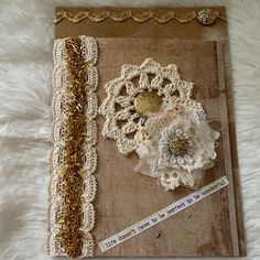 there is a piece of paper with lace and flowers on it