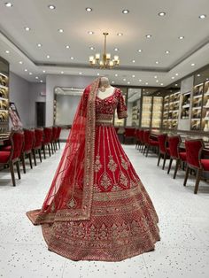 a red bridal gown on display in a store