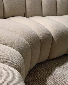 an upholstered couch with four curved cushions