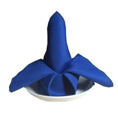 a blue napkin on top of a white bowl