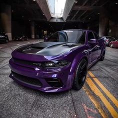 a purple car parked in an underground parking lot