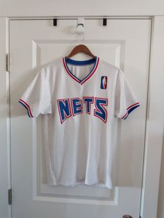 "Brooklyn Nets jersey in good condition, says AMO on back so it may be a sponsor but this is a very well made jersey. Size: fits like modern men's S or woman's M check additional measurements Pit to Pit      19\" Length         27\"" White Varsity Basketball Jersey, White Cotton Jersey For Sports Fans, White Cotton Fan Gear Jersey, White Basketball Jersey For Sports Season, White Baseball Jersey Fan Apparel, White Baseball Jersey For Streetwear, White Fan Apparel Jersey For Streetwear, Throwback White College Tops, White Throwback College Tops