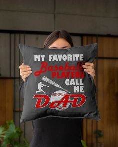 a woman holding a pillow that says, my favorite baseball players call me dad