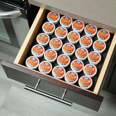 an open drawer with twelve cups of yogurt in it