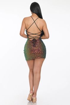 the back of a woman in a short dress, with her hands on her hips