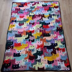 a multicolored rug with cats on it