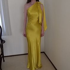 Stunning Evening Or Special Occasion Dress By Zara. It Is A Gorgeous Yellowish/ Gold Shade And Zips On The Side. The Dress Has A Beautiful Knotted Draping On The Left Side. This Dress Will Definitely Make Heads Turn. It Is New With Ticket. Fitted Yellow Evening Dress, Elegant Yellow Satin Midi Dress, Yellow Sleeveless Maxi Dress For Formal Events, Yellow Sleeveless Maxi Dress For Formal Occasions, Sleeveless Yellow Maxi Dress For Formal Occasions, Yellow One-shoulder Evening Midi Dress, Yellow One-shoulder Midi Dress For Evening, Yellow Sheath Dress For Parties, Yellow Satin Midi Dress For Party