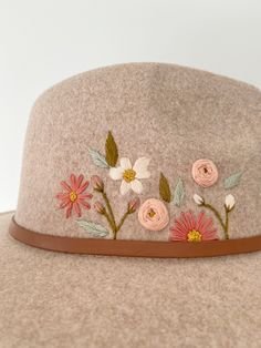 a hat with flowers embroidered on it