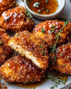 some fried food on a plate with dipping sauce