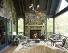 a living room filled with furniture and a fire place in the middle of a room