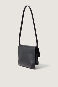 Black glazed leather bag - Shoulder bag- Two pleats- Cotton lining- Card holder inside- Height 18 cm, length 25 cm- LWG leather This piece is made of LWG GOLD certified leather. Rectangular Saddle Bag With Removable Pouch For Evening, Modern Rectangular Saddle Bag For Evening, Versatile Rectangular Saddle Bag For Formal Occasions, Modern Rectangular Saddle Bag For Evenings, Versatile Formal Rectangular Saddle Bag, Formal Rectangular Versatile Saddle Bag, Leather Rectangular Baguette Bag For Business, Rectangular Leather Baguette Bag For Business, Classic Pouch Box Bag With Detachable Strap