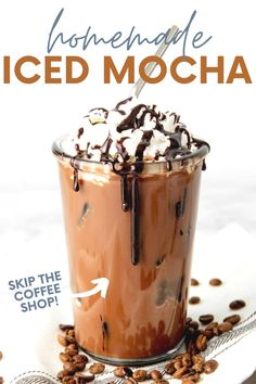 iced mocha in a tall glass with whipped cream and chocolate drizzle on top