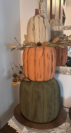 three pumpkins are stacked on top of each other