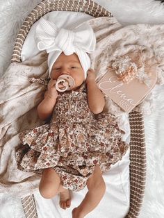 a baby is laying down with a pacifier in her mouth