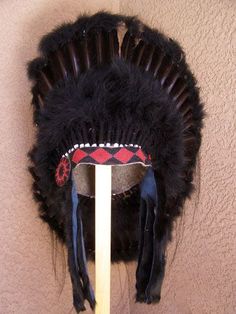 Discover the beauty and tradition of Native American culture with our Black Legend Warbonnet, carefully crafted by skilled Native American artisans. This stunning headpiece is a tribute to the traditional bonnets worn by Native Americans during the late 1800s and early 1900s. Embrace the rich history and spirit of this heritage piece. The bonnet has more than forty-eight black feathers sewn onto a heavy felt feather fluff-covered skull cap with a single honor feather in the center of the back. T Traditional Black Costume Hats And Headpieces For Ceremonial Occasions, Traditional Handmade Costume Hats And Headpieces, Traditional Black Costume Hats And Headpieces For Festivals, Traditional Black Costume Hats For Festivals, Traditional Black Ceremonial Costume Hats And Headpieces, Traditional Tall Crown Festival Headpieces, Traditional Headpieces For Costume Festivals, Traditional High Crown Costume Hats For Festivals, Traditional Adjustable Headpiece With Tall Crown