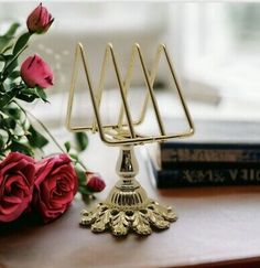 a gold menorah sitting on top of a table next to roses