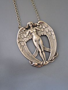 "Vintage Jewelry - Vintage Necklace - Art Nouveau Necklace - Angel Necklace - Brass Necklace - Statement Necklace - Chloe's Vintage Jewelry This is such a fabulous vintage Art Nouveau necklace! A large brass angel stamping with incredible detail. So very  feminine.  The pendant hangs from a vintage brass ladder chain. Chloe says, \"Wear it and feel fabulous!\" This pendant is 2 1/2\" tall.  You can choose the necklace length you would like at checkout. Thanks for visiting Chloe's" Bronze Jewelry With Artistic Design, Artistic Bronze Jewelry With Artistic Design, Handmade Art Deco Sterling Silver Necklace, Art Nouveau Jewelry With Artistic Design For Gift, Bronze Artistic Design Jewelry Gift, Gift Bronze Jewelry With Artistic Design, Artistic Large Pendant Necklace For Collectors, Art Nouveau Silver Brass Jewelry, Art Nouveau Pendant Necklaces For Jewelry Making