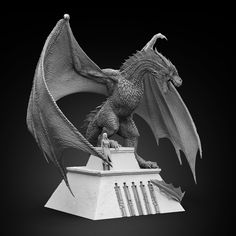 a black and white photo of a statue of a dragon on top of a building