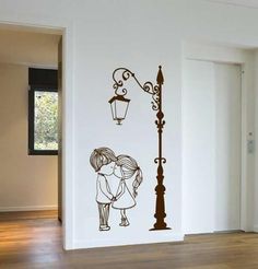 a couple kissing under a street light wall decal in a room with hardwood flooring