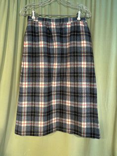 This is a cute vintage wool skirt, from the 60s or early 70s. Pendleton. The label has the woolmark symbol that dates it to the 60s or early 70s. No size tags. Waist measures 28", please see measurements.  Made of 100% wool in a plaid pattern in shades of gray, cream, blue & red.  It is an A-Line skirt, that reaches to below the knee. Closes with a button on the left side of the waistband. Skirt is fully lined. There is a pocket in the right side hip.  The skirt is in very good condition. No soil or stains.  No holes or tears. No moth nibbles. No fading. Sweet! Measurements were taken with the garment lying flat. If you have never worn vintage before, please measure yourself!! Will fit best if your measurements are a little smaller than the measurements given. If you have any questions abo Vintage Wool Lined Skirt, Retro Wool Skirt For Winter, Vintage Plaid Skirt For Work, Vintage Wool Skirt, 70s Clothes, Shades Of Gray, Alt Fashion, Little Outfits, Wool Skirt