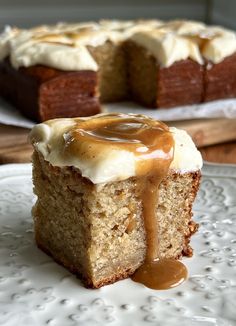 a piece of cake on a plate with caramel sauce drizzled over it