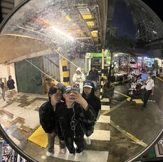 two people taking a selfie in front of a mirror