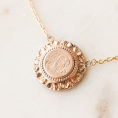 This one-of-a-kind necklace is composed of: Victorian medallion from the late 1800s with the initials "GLB" hand-engraved in the center. This necklace measures a standard 18” on a modern 14k gold filled chain, with the pendant measuring 0.875" in height. Heirloom Coin Pendant Jewelry, Engraved 14k Gold Oval Pendant Locket Necklace, Etched 14k Rose Gold Jewelry, Oval Engraved 14k Gold Necklace, Rose Gold Medallion Jewelry With Engraving Option, Formal 14k Gold Engraved Locket Necklace, Heirloom Oval Engraved Necklaces, Heirloom Sterling Silver Necklace Stamped 14k, Engraved Rose Gold Heirloom Locket Necklace