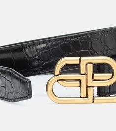 The golden BB logo from Balenciaga serves as the buckle – and centerpiece – of this black belt. The design has been crafted in Italy from croc-effect calf leather, and it has stud-adjustable closure and a keeper strap. Let yours cinch billowing dresses for a dose of modern flair..Closure: buckle fastening.Color of fastening: antique gold.Comes with dust bag.Made in Italy.Material: calf leather.Width 2,5cm-1'.Buckle width 3cm-1' Balenciaga Crocs, Bb Logo, Black Balenciaga, Balenciaga Women, Balenciaga Black, Metallic Leather, Black Belt, Belts For Women, The Golden