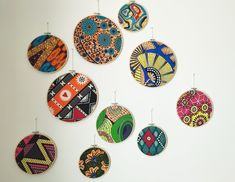 a group of colorful ornaments hanging on a wall