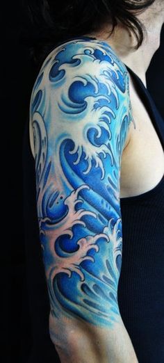 a woman's arm with blue waves on it