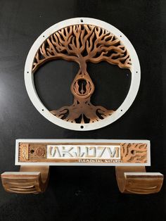 a wooden plaque with a tree on it