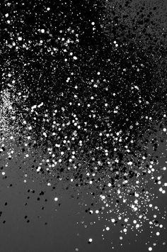 black and white photograph of bubbles floating in the air on a dark background with space for text