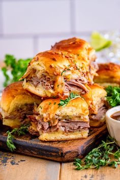 sandwiches stacked on top of each other with dipping sauce