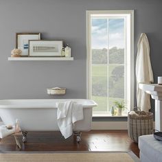 a white bath tub sitting next to a window