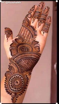 a woman's hand is decorated with hennap and intricate designs on it