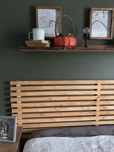 a bed with two pictures on the wall above it and a wooden slatted headboard