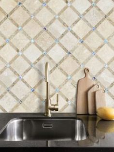 a kitchen counter with a sink and cutting board