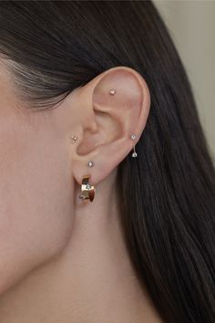 a close up of a person wearing ear piercings on their left and right ears