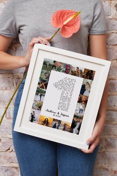 a woman holding a framed photo and flower