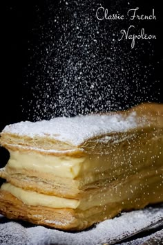 a stack of pancakes covered in powdered sugar