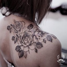 the back of a woman's shoulder with flowers on it