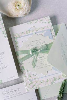 the wedding stationery is laid out on the table