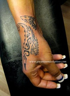 a woman's arm with a tattoo on it and a hand holding the wrist