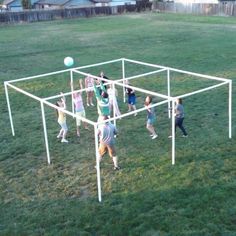 several people playing with a ball in an open field