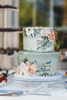 a three tiered cake with flowers on it