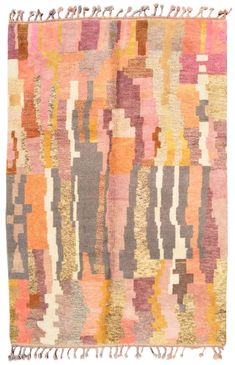 an old rug with many different colors and patterns on the surface, including pinks, oranges, yellows and browns