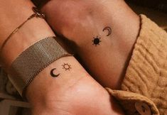 two people with matching tattoos on their arms, one has a sun and the other has a moon