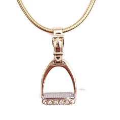 Ashley's signature 14k gold Diamond Medium Stirrup Pendant is designed with a detailed pad in white gold to simulate an actual stirrup. Each stirrup is hand made and hand finished for superior quality by Ashley's with .12ct diamonds, 5/8"W x 1 1/4"L (including strap). Add a chain to make a beautiful Equestrian Necklace Sold separately. Available in all White Gold upon request. Equestrian Necklace, Horseshoe Jewelry, Horseshoe Necklace, Equestrian Jewelry, Pendant Diamond, Horse Necklace, Horse Jewelry, Dog Jewelry, Accessories Ideas