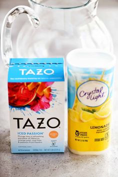 a glass pitcher and carton of tazo next to it